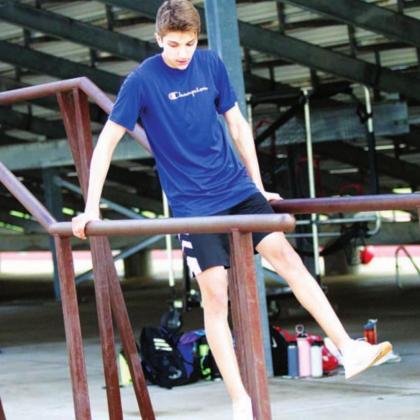 Luke Shivers works on the parallel bars during SWAT in the summer of 2021. FILE PHOTO