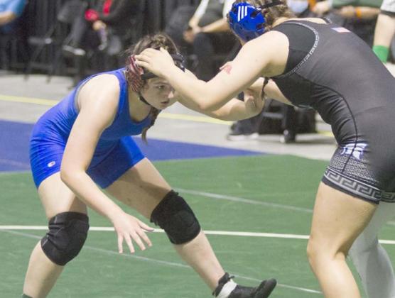 Mia Martell, left, wrestles against a Burleson Centennial Lady Spartan on Friday at the state tournament in Cypress. JEFF LOWE | DISPATCH RECORD