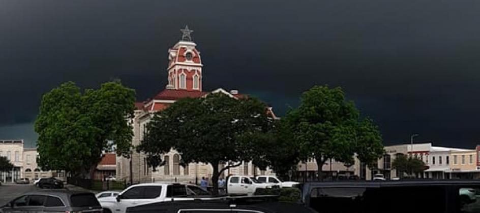 Storm clouds hover over downtown square on stormy Monday