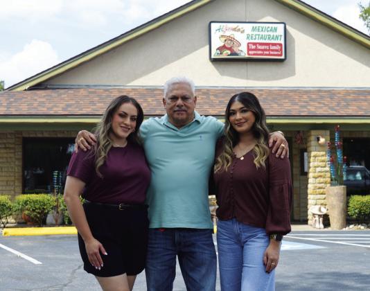 Alfredo Suarez stands with daughters Arleny, left, and Valeria outside his restaurant on U.S. Highway 281 South. The family-owned business takes pride in treating customers like they are special kinfolk, too. The Mexican restaurant will host a twoday celebration next week in honor of its 20 years of operation in Lampasas. ERICK MITCHELL | DISPATCH RECORD