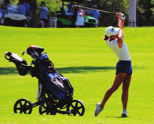 Shaylee Wolfe finishes on a shot from the fairway on the 12th hole at Legends Golf Course in Kingsland. HUNTER KING | DISPATCH RECORD