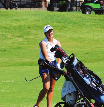 Shaylee Wolfe smiles after a shot during the state golf tournament on Tuesday. HUNTER KING | DISPATCH RECORD