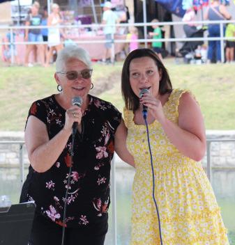 joycesarah mccabe | dispatch record Mother-daughter duo with Connie Barham, left, and Jaci Barham entertain those gathered to listen to music in W.M. Brook Park during Spring Ho activities.