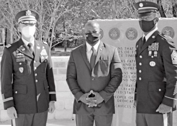 Lt. Col. Robert Phillipson, left, Kempner Mayor Dr. Keith Harvey, center, and Command Sgt. Maj. Charles Chapelle stand at the veterans’ monument at Sylvia Tucker Memorial Park. JEFF LOWE | DISPATCH RECORD