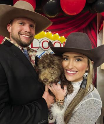 Amanda Bowen, right, was the top bidder in the puppy auction at Saturday’s Wild West Casino Night. She and her husband took home the cuddly animal at the end of the event. STEPHANIE FITZHARRIS | COURTESY PHOTO