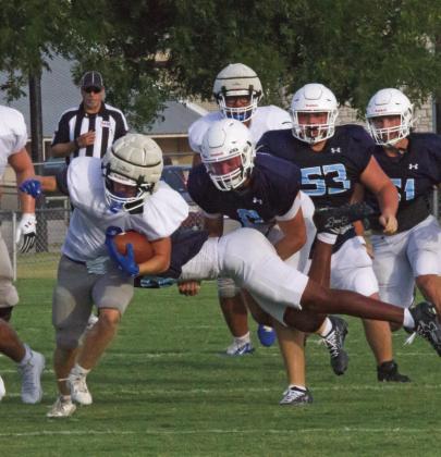 The Badgers look for an open lane on a rushing play against the Liberty Hlll Legacy Ranch Wranglers last Friday in the season’s first scrimmage. JEFF LOWE | COURTESY PHOTO