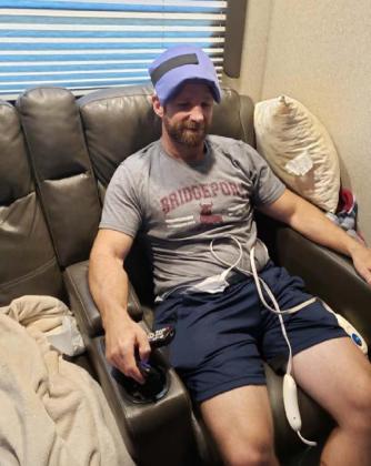 Chris Murrell treats his headache with a cold compress and his joint aches with heating pads during the throes of his COVID-19 infection. ALEXANDRIA RANDOLPH MURRELL | DISPATCH RECORD