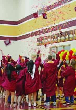 Students of the Lometa High School Class of 2023 celebrate by throwing their caps in the air. MASON HINES | DISPATCH RECORD
