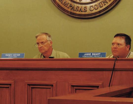 County Judge Randy Hoyer, left, and Commissioner Jamie Smart listen to discussion about changing language in the burn ban to permit the use of fireworks. HUNTER KING | DISPATCH RECORD