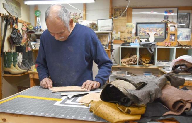 Lampasas bootmaker Pablo Jass measures a piece of leather as he cuts it into a vamp. MADELEINE MILLER | DISPATCH RECORD