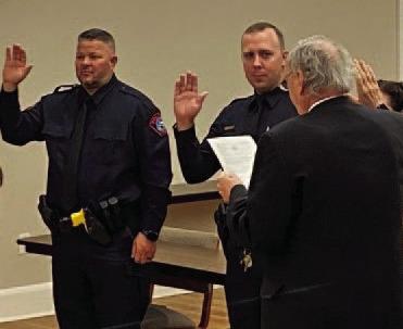 Lampasas Municipal Judge Robert Gradel administers the oath of office to incoming police officers Jacob Loeve and Jeff Phillips. COURTESY PHOTO