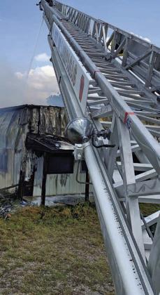FILE PHOTO Lampasas Fire Department’s ladder truck, shown with its aerial ladder extended while Jared Payne fights a fire several years ago, has reached the end of its service life, according to national standards.