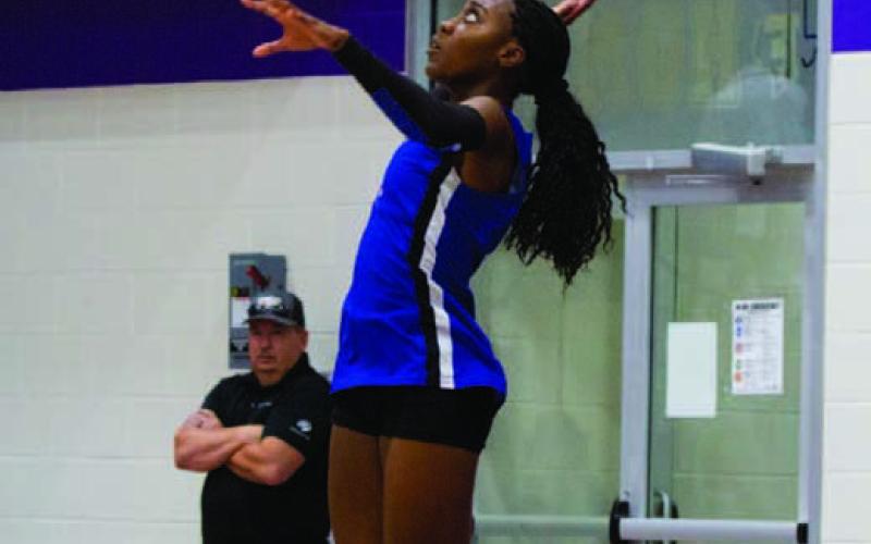 Angelina Davis leaps into the air and levels her serve over the net. Davis’ seven kills on the night were a team-high in the program sweep over Florence. ANA SOFIA MEYER | DISPATCH RECORD
