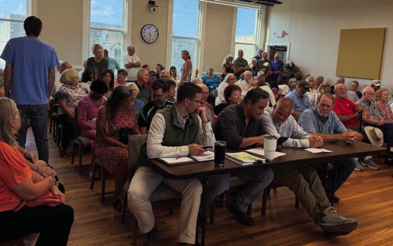 ERICK MITCHELL | DISPATCH RECORD Council Chambers was filled Thursday with a standing-room-only crowd, and some residents had to listen from the stairwell area as residents offered input on a proposed zoning change. Many were concerned about possible traffic congestion and lower property values that could result from the housing change.