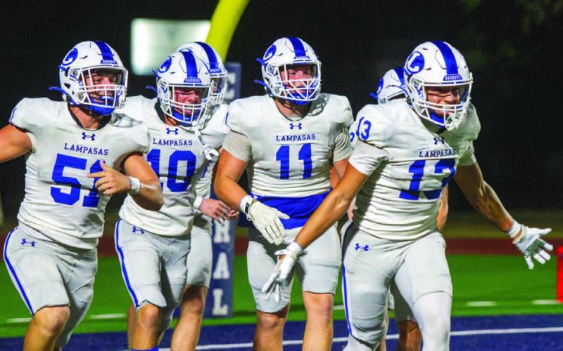 The Badgers’ defense, including Rylan Chapa (13), Campbell Roberts (51), Brayden Roberts (11) and Colton Harper (10) celebrate scoring a safety against Central Catholic before halfimte, the two points that allowed the Badgers to prevail before the game was canceled due to weather. ANA SOFIA MEYER | DISPATCH RECORD