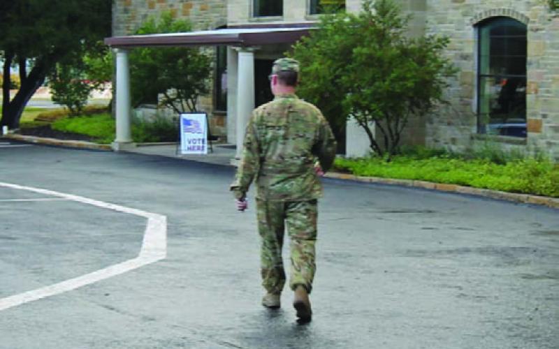 This soldier heads to the vote center at New Covenant Church Tuesday morning to cast his ballot. JOYCESARAH MCCABE | DISPATCH RECORD