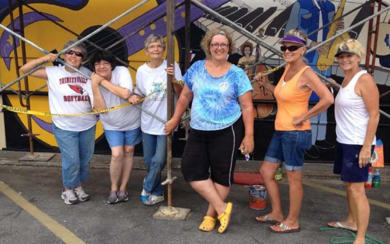 Vision Lampasas members pose for a picture as they paint “Small Town . . . Big Sound.” COURTESY PHOTO