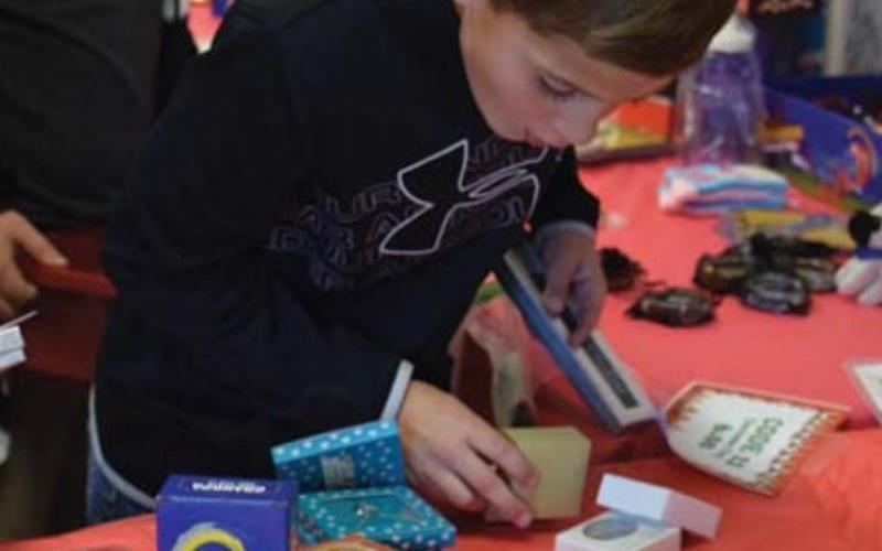 Cutter Sellers examines some gift possibilities at the Peppermint Village Gift Shop. ALEXANDRIA RANDOLPH | DISPATCH RECORD