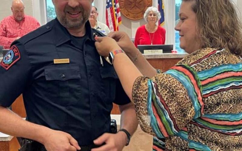 Renee Cummings pins the brass on her husband, newly appointed Lampasas Police Chief Jody Cummings. COURTESY PHOTO