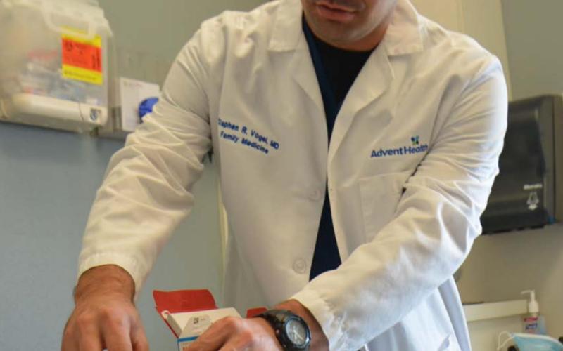 Dr. Stephen Vogel, a physician at AdventHealth Central Texas Family Medicine Clinic-Lampasas holds a Moderna vaccine in his office in this July 2021 photo. FILE PHOTO