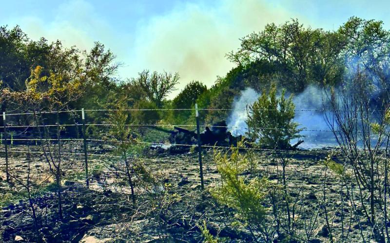 JOYCESARAH MCCABE | DISPATCH RECORD Smoke rises from a charred section of ground during the Lucy Creek fire on Sunday afternoon.