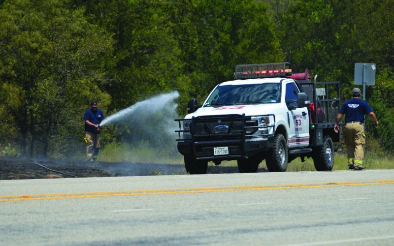 Adamsville Volunteer Fire Department firefighters work to extinguish a grass fire along U.S. Highway 281, about five miles south of Adamsville. ERICK MITCHELL | DISPATCH RECORD