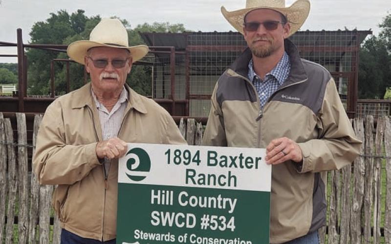 Grady Gibson, left, of Hill Country Soil and Water Conservation District #534, presents Weston McCoury with the Area 5 Conservation Rancher Award for work done on the Baxter Ranch near Bend. COURTESY PHOTO