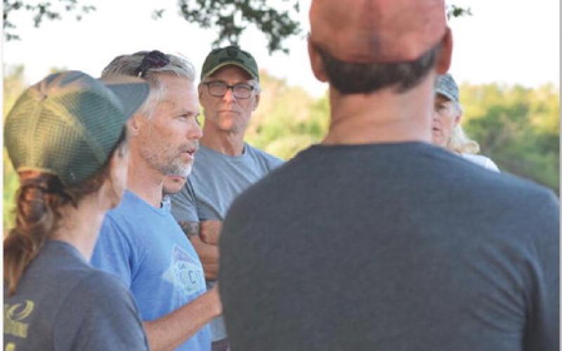Kristi Allison and Shannon Martin, at left, address a group of volunteers gathered to prep the trail corridors on Saturday morning. ALEXANDRIA RANDOLPH | DISPATCH RECORD