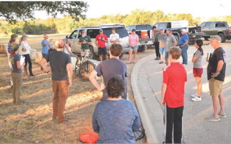 Mike Hiler provides a safety briefing for the volunteers prior to the start of work at the 580 Sports Park. ALEXANDRIA RANDOLPH | DISPATCH RECORD