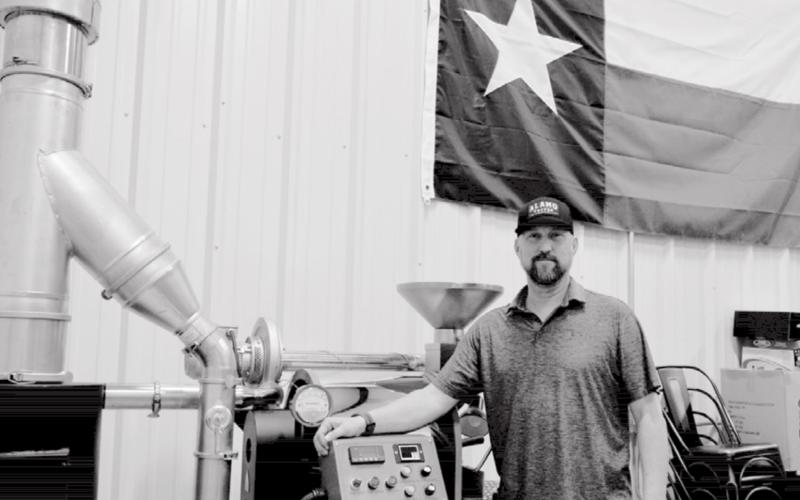 Alamo Coffee Company owner Aaron Cornish stands by a roasting machine in Alamo’s Lampasas warehouse. The machine will move to Alamo’s café so customers can observe the roasting process. MADELEINE MILLER | DISPATCH RECORD