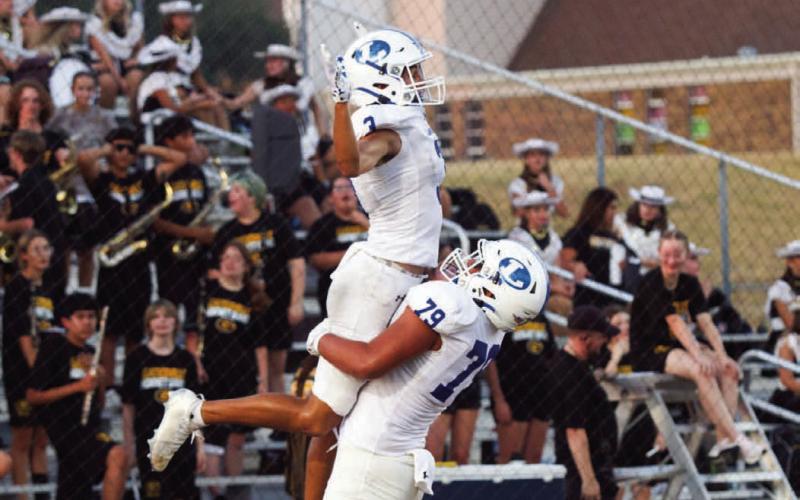 Senior wide receiver Tripp Stinnett celebrates his first touchdown of the season against Gatesville with offensive lineman Pablo Cortez. Stinnett finished the night with two receiving touchdowns. ANA SOFIA MEYERL | DISPATCH RECORD