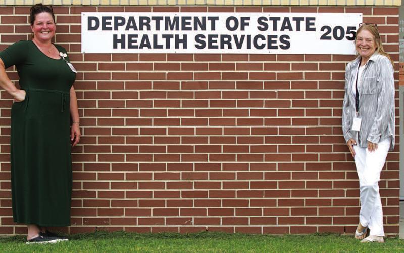 From left, Department of State Health Services staff at the Lampasas clinic, nurse Dee Edwards and specialist Tammy Pastor, pose for a photo outside the building located at 205 Water Street. ERICK MITCHELL | DISPATCH RECORD