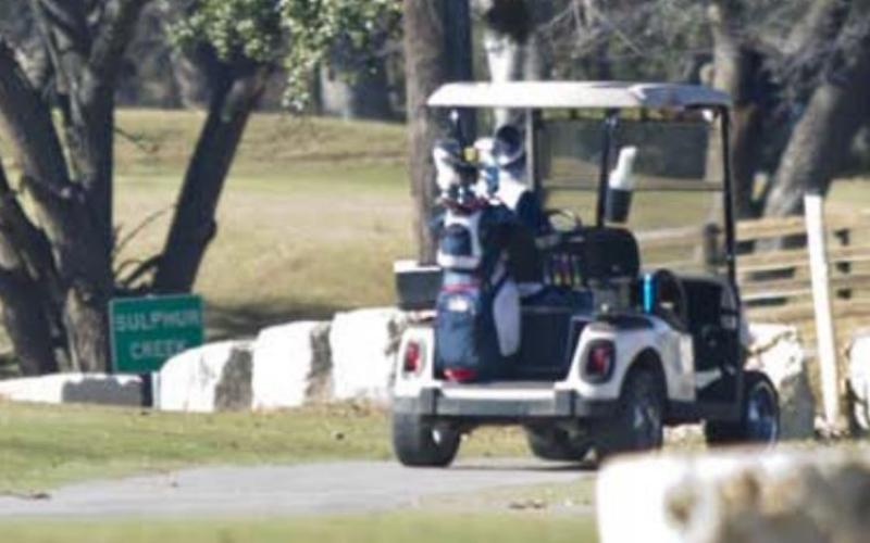 Golf cart drivers at Hancock Park Golf Course prepare to cross Naruna Road. A city ordinance stipulates that licensed drivers may operate golf carts on public roadways only to travel to and from cemeteries and the golf course. JEFF LOWE | DISPATCH RECORD
