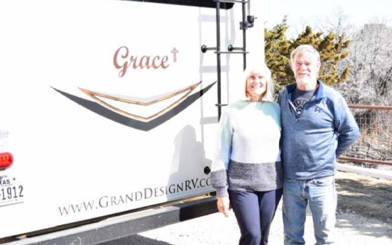 Tim and Kathy McPherson pose by their fifth-wheel RV that they have named “Grace.” ALEXANDRIA RANDOLPH | DISPATCH RECORD