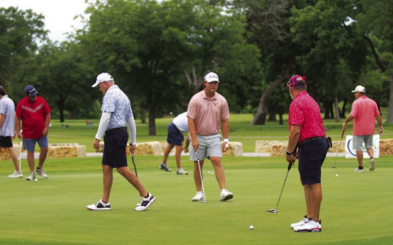 HUNTER KING | DISPATCH RECORD Players practice putting ahead of the final round on Memorial Day.