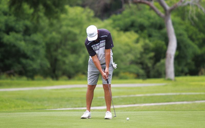 HUNTER KING | DISPATCH RECORD Ryan Shahan hits a putt on the 18th hole during the annual tournament.