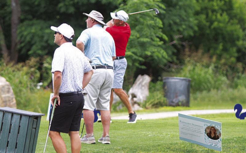 HUNTER KING | DISPATCH RECORD Players watch a tee shot fly toward the sixth green at Hancock Park Golf Course.