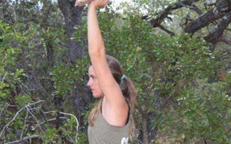 A “waiter’s hold” is a press and hold overhead with a single hand. Flat objects like books, pans or even a flat rock present a challenge to the stabilizing muscles of the shoulder. Alexandria Randolph | dispatch record