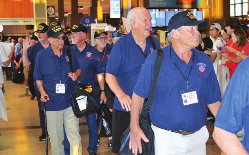 Veterans who participated in an Honor Flight to Washington, D.C. last week were greeted Saturday night by a large crowd at Austin’s Bergstrom International Airport upon their arrival back from the nation’s capital. Lampasas resident James Welch, left side of photograph holding a carry-on bag, served with the Marines during the Korean War. JIM LOWE | DISPATCH RECORD