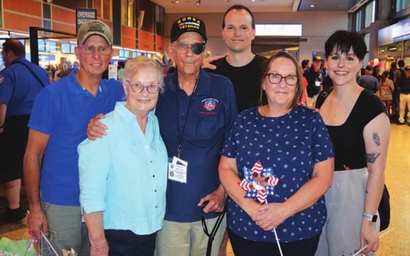James Welch is pictured at the airport with family members. From left: son Zac Welch; Anne Welch, James’ wife; Welch; grandson William Welch; James Welch’s daughter Denise Momberg; and granddaughter Emily Momberg. James, Zac and William all served in the Marines. A special point of family pride is William’s service as a crew chief aboard the Marine Two backup presidential helicopter. Not pictured: daughter Kristy Welch. JIM LOWE | DISPATCH RECORD