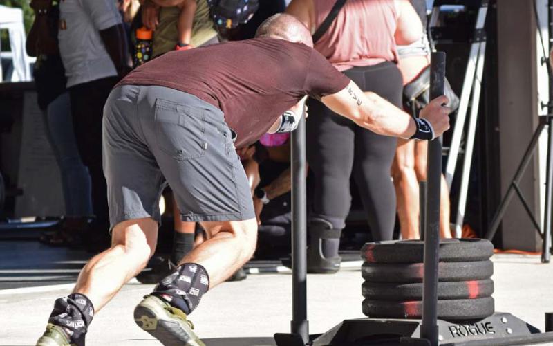 A competitor in a functional fitness competition pushes a sled with a total weight of 187 pounds across a distance in a timed trial. Pushing one’s own limits is the only way to experience significant change, whether that be in fitness, habits and routine, or matters of lifetime accomplishment. alexandria Randolph | dispatch record