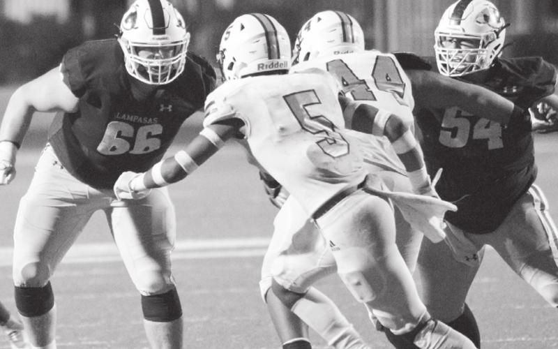 Junior Caden Thrift (66) and senior Hayden Waldrip (54) block in the fourth quarter of last week’s playoff game as the previously undefeated Badgers attempted a 19-point comeback. JEFF LOWE | DISPATCH RECORD