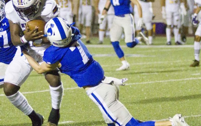 Cody Hinson (7) tackles McCullion Williams as he returns a kick for Corpus Christi Miller in the Badgers’ 54-49 area championship loss to the Buccaneers. JEFF LOWE | DISPATCH RECORD