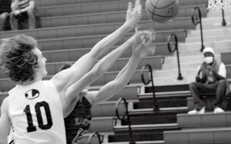 Kaeden Crawford fights for control of the ball at the boards. Crawford led the Badgers’ scoring Tuesday with 17 points against the Austin Achieve Polar Bears. JEFF LOWE | DISPATCH RECORD