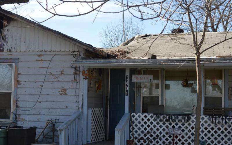 erick mitchell | dispatch record Three people were displaced after a fire significantly damaged a home in the 1400 block of East Third Street on Monday morning.