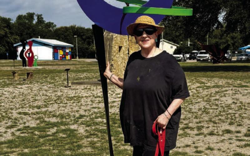 Michelle O’Michael stands by her sculpture “Honoring Trees” after it was installed in the Hanna Springs Sculpture Garden earlier this month. COURTESY PHOTO | LAFTA