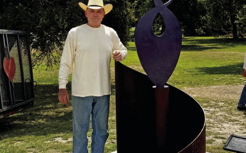 Anthony St. James poses with his sculpture “Healing Community.” COURTESY PHOTO | LAFTA