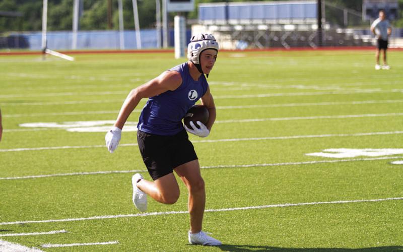 HUNTER KING | DISPATCH RECORD Cody Romine runs up the sideline after catching a pass.