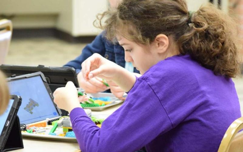 Isabella Gutierrez builds an earthquake simulation plate out of LEGO blocks using step-by-step instructions. ALEXANDRIA RANDOLPH | DISPATCH RECORD
