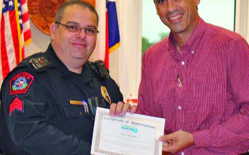 Lampasas ISD Superintendent Dr. Chane Rascoe had praise for School Resource Officer Steve Sheldon, who was named a Community Champion at a meeting of the Lampasas City Council on Monday. Sheldon and Rascoe are pictured left to right. COURTESY PHOTO